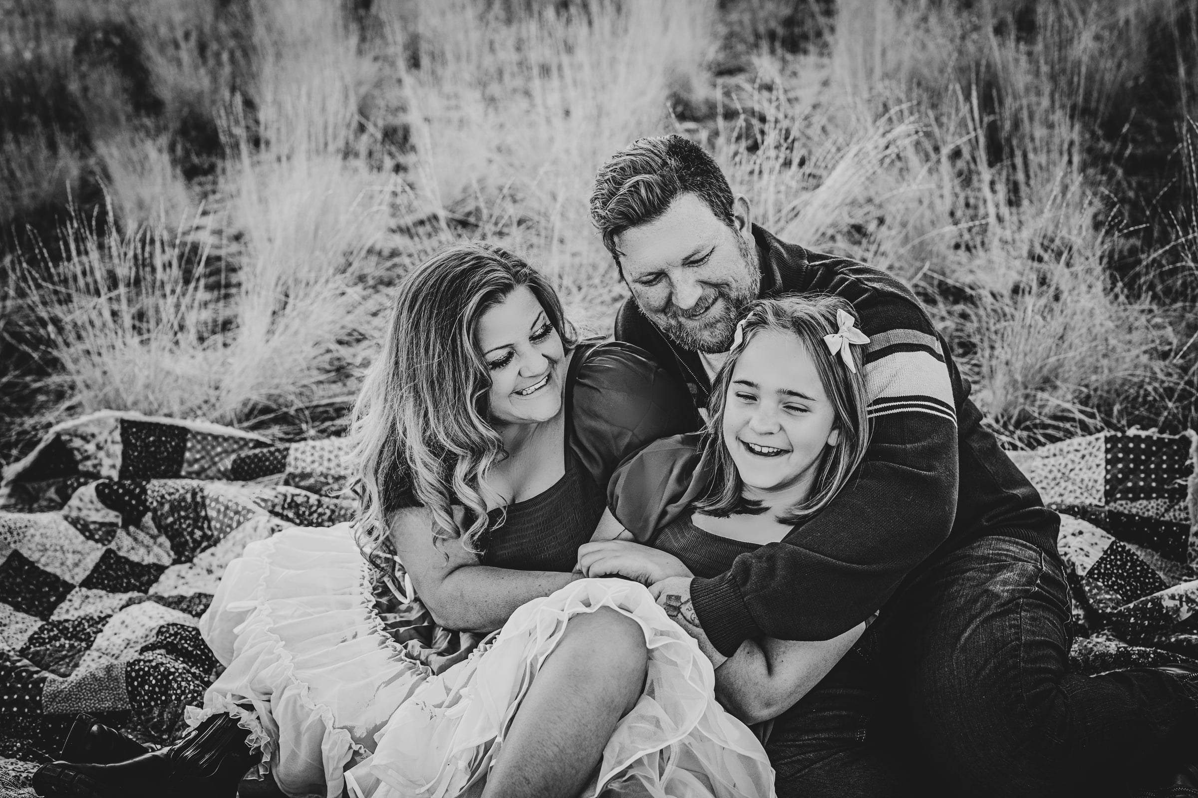 Family laughing together during a year-round Tri-Cities portrait session