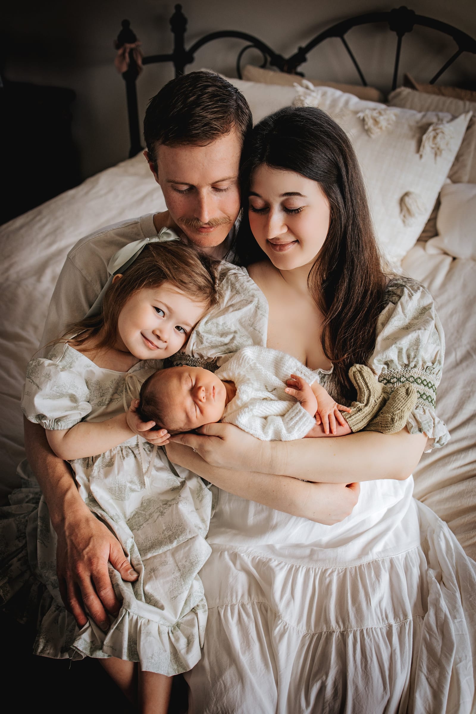A family together with their newborn at home.