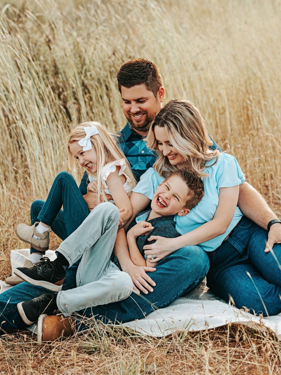 A family laughing together during an outdoor Tri-Cities portrait session