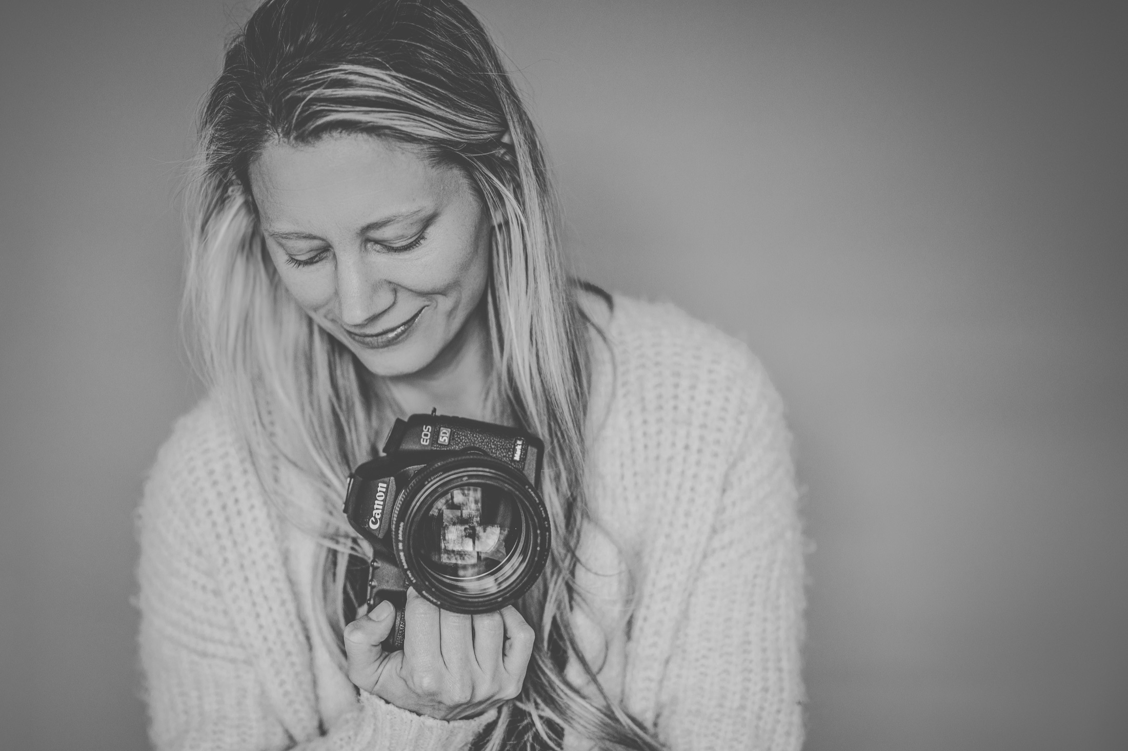 Lisa Weiss reviewing her camera while working on a photography session.