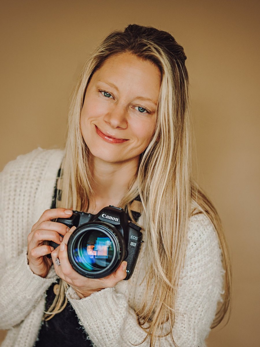 Lisa, owner of It’s A Keeper Photography, holding her camera in the Tri-Cities